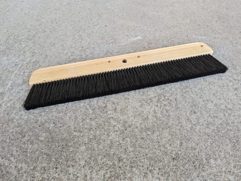 Concrete finishing brush head. Black bristles.