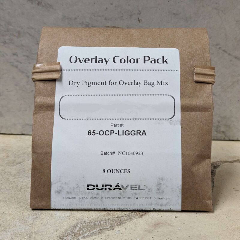 Duravel individual color pack, small paper bag with label. The color name is blurred out, but the actual product will have the color name in bold capital letters.