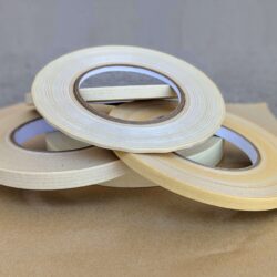 Various sizes of paper filament tape arranged in a loose stack