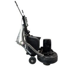 Industrial floor grinder and polisher with attached vacuum hose, black in color, isolated on a white background.