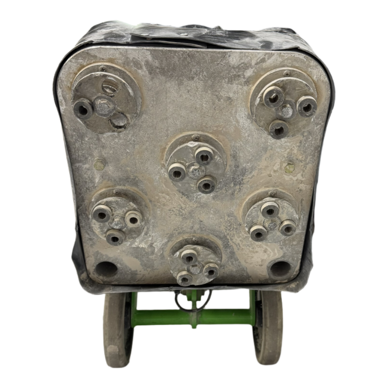 A front view of the Rhino 150 Grinder metal component with multiple bolts, mounted on a green two-wheeled dolly, set against a white background.